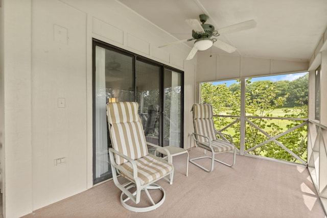 sunroom / solarium with ceiling fan and vaulted ceiling