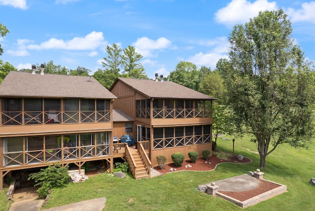 back of property with a sunroom and a lawn