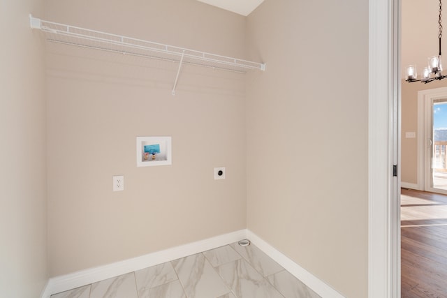 clothes washing area featuring hookup for an electric dryer, hardwood / wood-style floors, a chandelier, and washer hookup