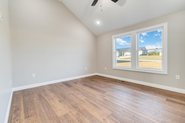 spare room with hardwood / wood-style flooring, ceiling fan, and vaulted ceiling