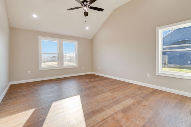 unfurnished room with ceiling fan, light wood-type flooring, and vaulted ceiling