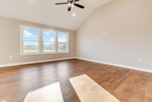 spare room featuring light hardwood / wood-style floors, lofted ceiling, and ceiling fan