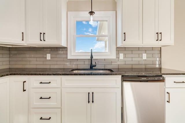 kitchen featuring stainless steel dishwasher, sink, white cabinets, and decorative light fixtures