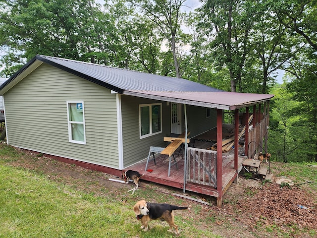 back of house featuring a porch