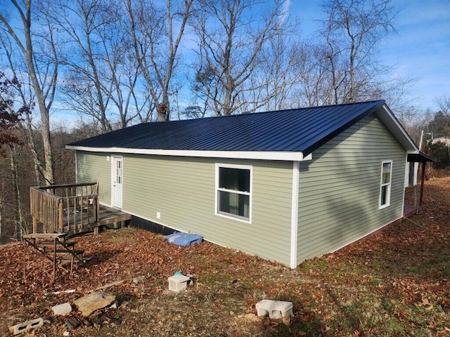 view of home's exterior featuring a wooden deck