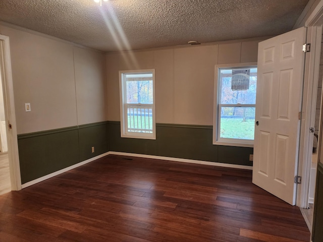 unfurnished room featuring a textured ceiling and dark wood-type flooring