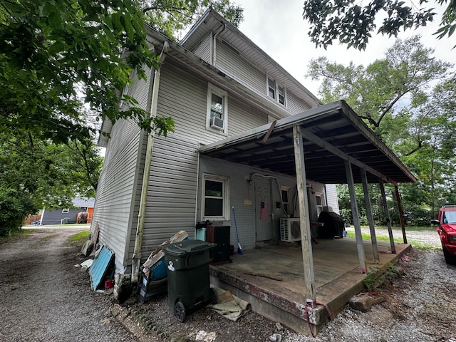 back of property with a carport