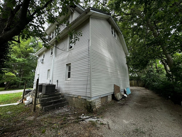 view of side of home featuring central air condition unit