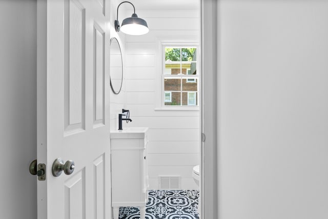 bathroom with tile patterned flooring, vanity, and toilet