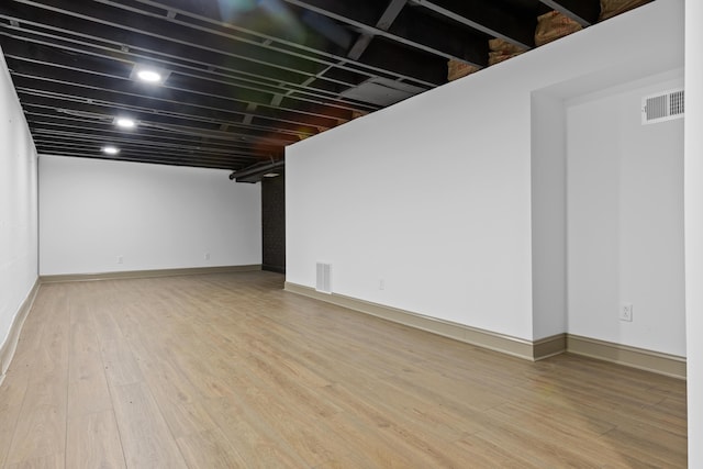 basement with hardwood / wood-style flooring