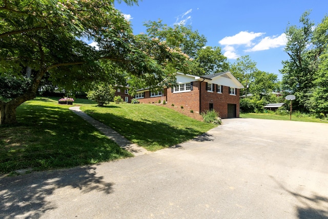 view of property exterior featuring a lawn and a garage