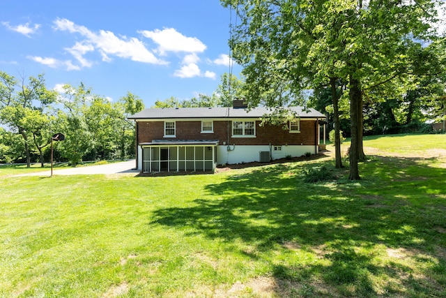 back of property with a lawn and cooling unit