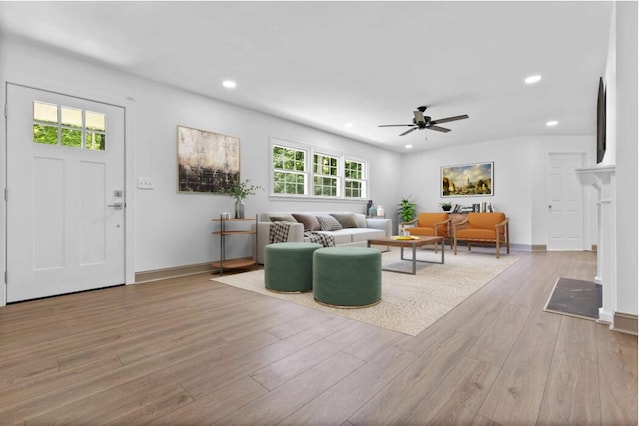 living room with ceiling fan and light hardwood / wood-style floors