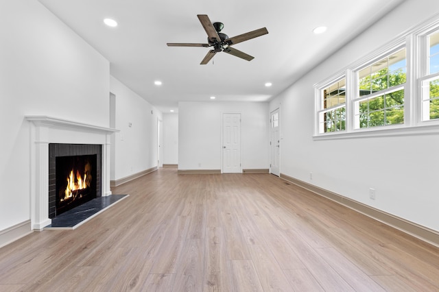 unfurnished living room with ceiling fan and light hardwood / wood-style flooring