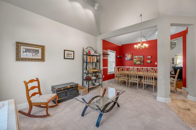 sitting room featuring a chandelier, carpet flooring, rail lighting, and vaulted ceiling