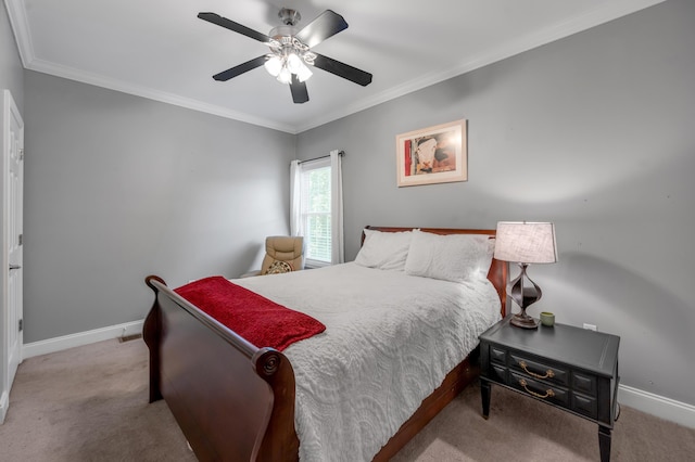 carpeted bedroom featuring ceiling fan and ornamental molding