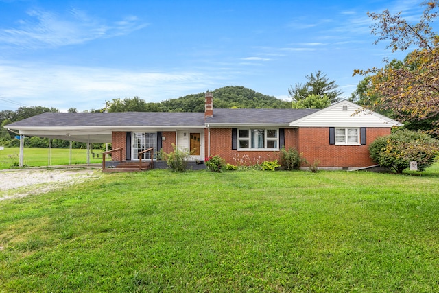 ranch-style house featuring a carport and a front lawn