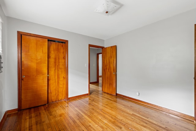 unfurnished bedroom featuring light hardwood / wood-style floors and a closet