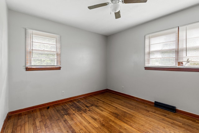 spare room with hardwood / wood-style flooring, plenty of natural light, and ceiling fan