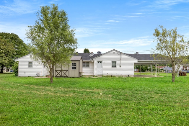 rear view of house with an outbuilding and a lawn