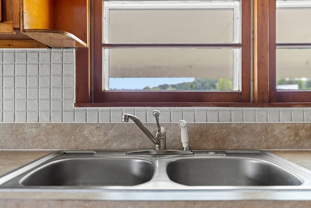 room details featuring sink, tasteful backsplash, and custom range hood