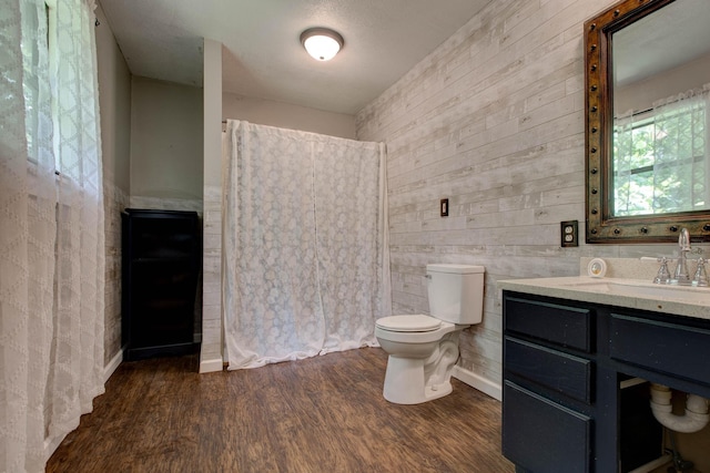 bathroom featuring wood-type flooring, vanity, and toilet