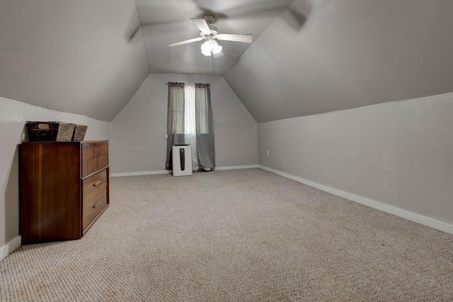 bonus room with ceiling fan, light colored carpet, and vaulted ceiling