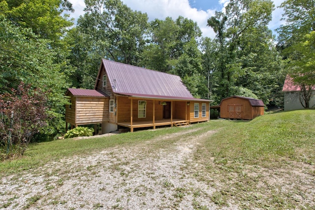 cabin with a front yard and a storage shed