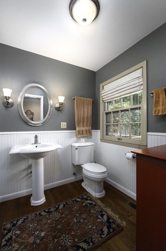 bathroom with hardwood / wood-style flooring and toilet