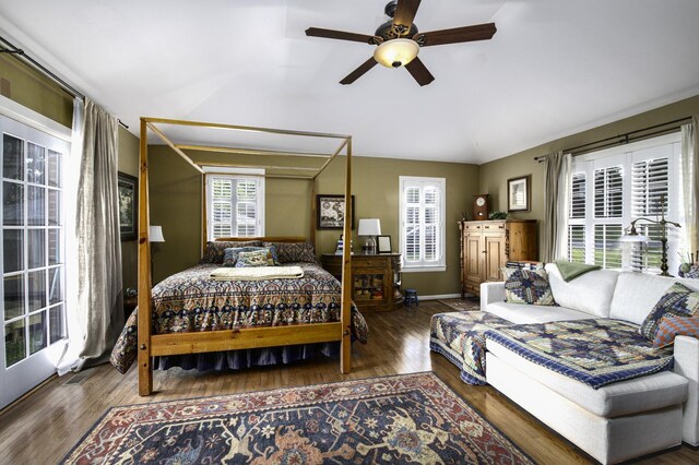 bedroom featuring ceiling fan, multiple windows, and hardwood / wood-style flooring