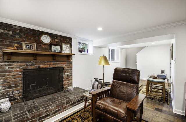 sitting room with a fireplace and wood-type flooring