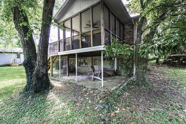 back of house featuring a patio, a sunroom, and a yard