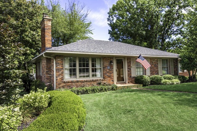 ranch-style house with a front lawn