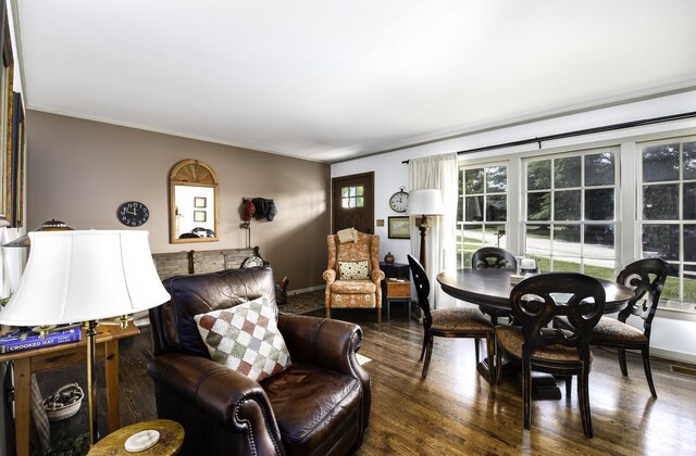 living room with crown molding, hardwood / wood-style floors, and a wealth of natural light