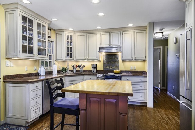 kitchen with white cabinetry, butcher block counters, stainless steel electric stove, a center island, and dark hardwood / wood-style flooring