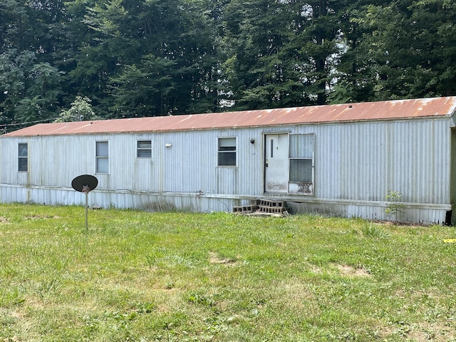 view of outdoor structure featuring a lawn