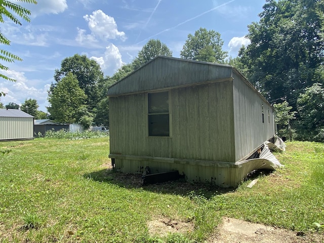 view of outbuilding featuring a lawn