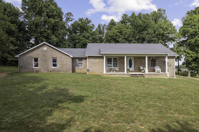 single story home with covered porch and a front yard