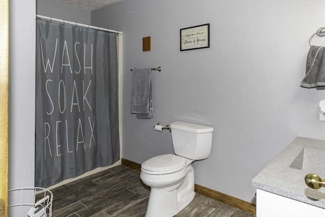 bathroom with a shower with curtain, vanity, and toilet