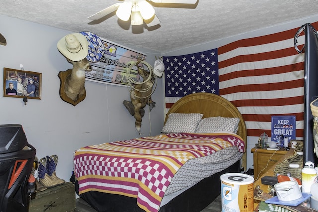 bedroom with a textured ceiling and ceiling fan