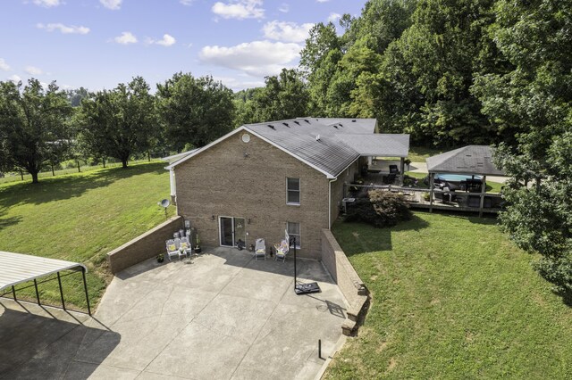 rear view of house with a deck and a yard