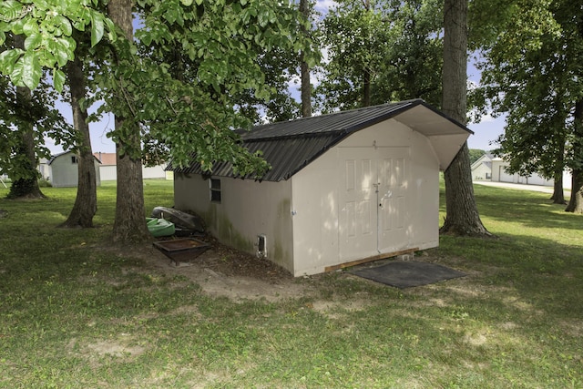 view of outdoor structure with a lawn