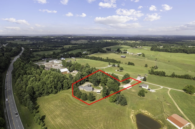 birds eye view of property with a rural view