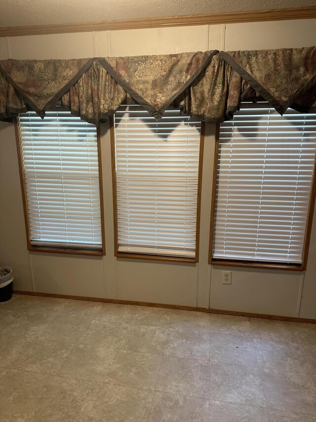 details with a textured ceiling and tile patterned flooring