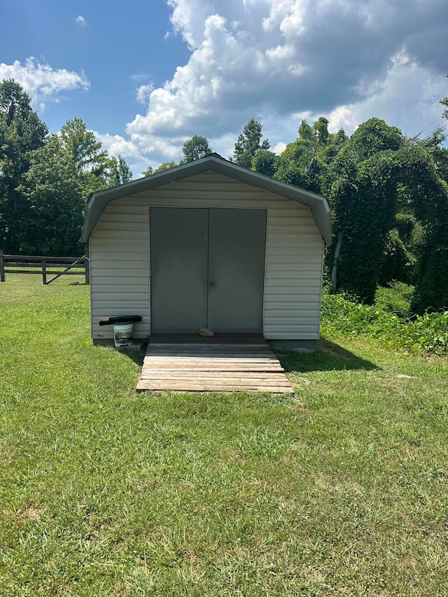 view of outbuilding with a yard