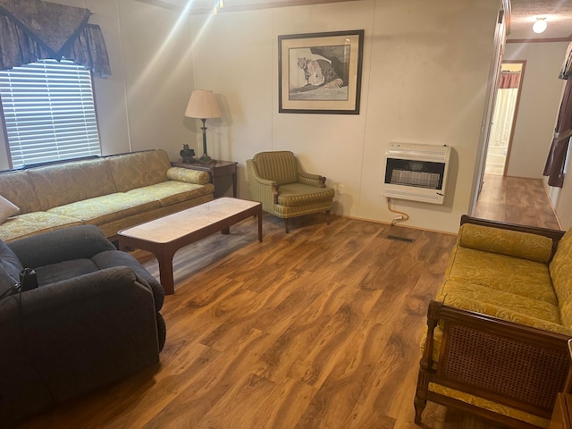 living room featuring heating unit and wood-type flooring