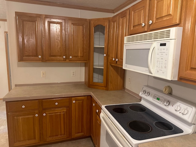 kitchen with crown molding and white appliances