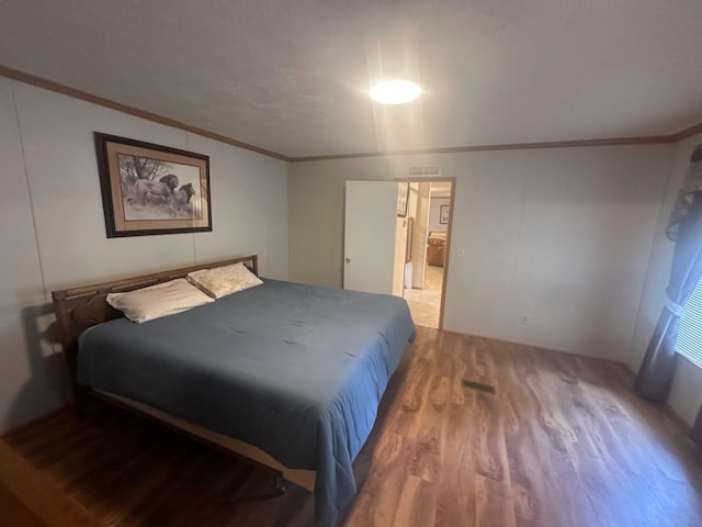 bedroom with hardwood / wood-style flooring