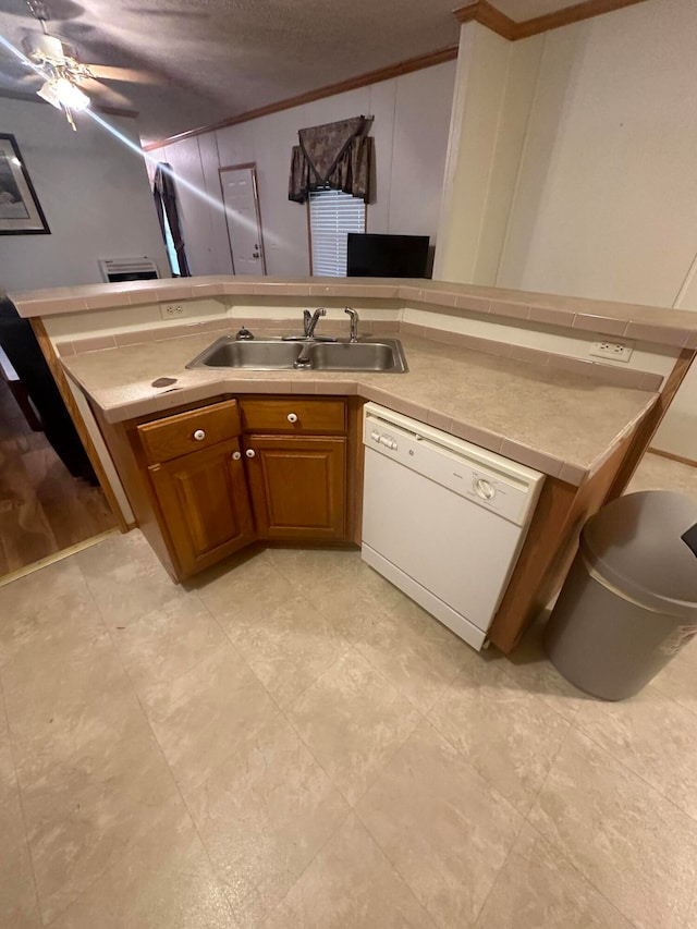 kitchen with light tile patterned flooring, crown molding, dishwasher, ceiling fan, and sink