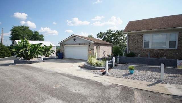 view of front facade with a garage and an outbuilding